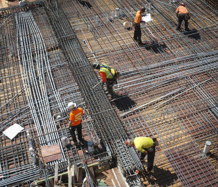 Construction workers laying re-bar.のeditorial素材