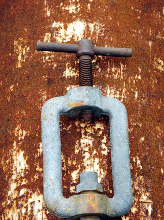 Rusty screw on rusty metal plate