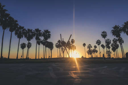 Beautiful Venice beach area in Los Angeles with a pedestrian walk during orange sunset. Empty beach, golden sand, no people.の写真素材