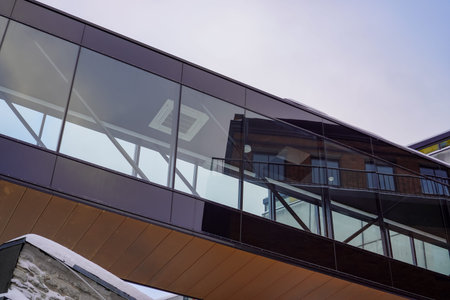 Modern building with glass and wooden features in a winter setting at Ulemiste city.