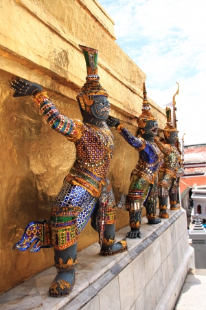 Thai giant stand around gold pagoda in Wat Phra Keaw, Bangkok ,Thailandの写真素材