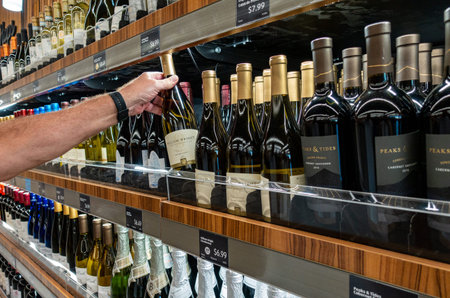Ft. Pierce,FL/USA-810/19: A man selecting a bottle of wine at grocery store.