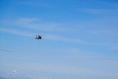Alaska/USA-9/11/19:A U.S. Coast Guard helicopter performing a medical evacuation for a cruise ship passenger.のeditorial素材