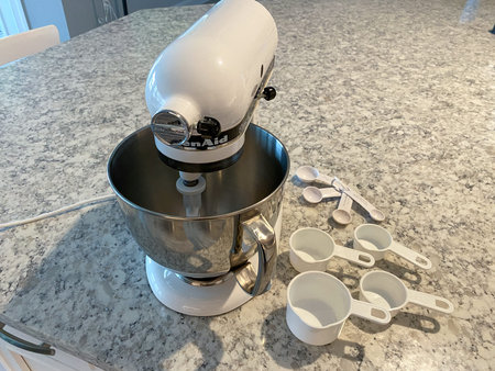 Orlando, FL USA - April 5, 2020: A Kitchenaid Mixer on a kitchen counter with measuring cups and...