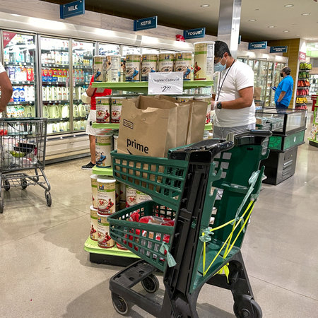 Orlando, FL USA - January 24, 2021: Amazon Prime Fresh employees shopping at a Whole Foods grocery store selecting food for for people to have delivered to their homes.のeditorial素材
