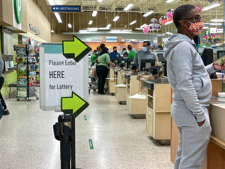 Orlando,FL USA - January 15, 2021:  People waiting in line to purchase lottery tickets at a Publix...