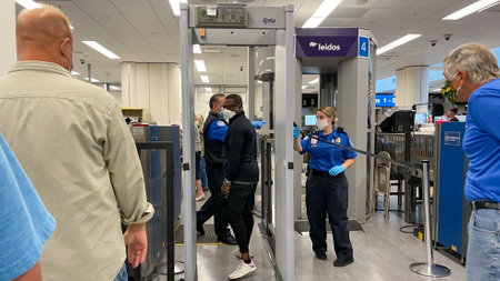 Orlando, FL USA - September 23, 2021:  People walking through the security line at Orlando International Airport MCO.のeditorial素材
