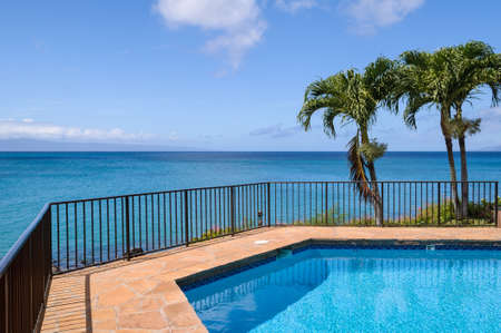 A swimming pool overlooking the ocean in Hawaii の写真素材