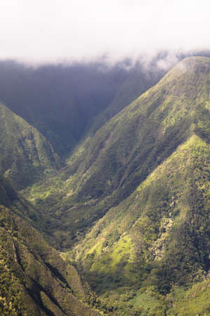 An aerial view of the mountains on Maui on a cloudy day の写真素材