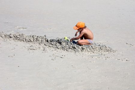Pattaya, Thailand - February 26, 2010 - A Child having fun in sand at the Coral Island Beach, Pattayaのeditorial素材