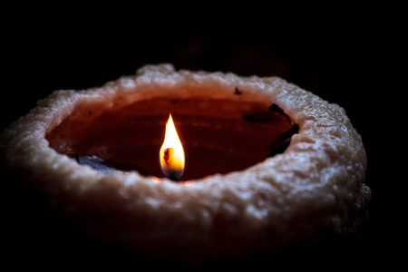 Candle Fading into Black Backgroundの写真素材