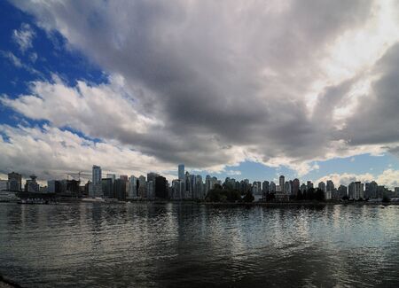 View From Stanley Park To Large Clouds Above The Vancouver Skylineの写真素材