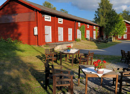 Red Wooden House In Church Town Gammelstad Near Lulea On A Sunny Summer Day With Some Clouds In The Skyの写真素材