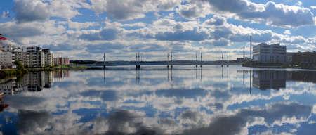Panoramic View From Bauers Brygga To Munksjobron Bridge In Jonkoping On A Sunny Summer Day With Some Clouds Reflecting In The Waterの写真素材