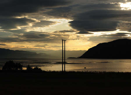 Fjord Landscape Between Alta And Sorkjosen At Dusk On A Sunny Summer Day With A Clear Blue Sky And A Few Cloudsの写真素材