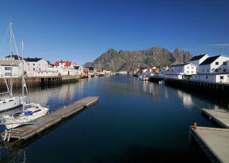 Harbor Of the Small Fishing Village Henningsvaer On Lofoten Island Austvagoy On A Sunny Summer Day With A Clear Blue Skyの写真素材