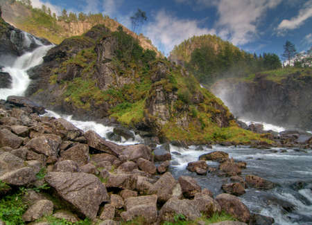 Latefossen Falls Flowing Into The Gronsdalslona River On A Cloudy Summer Dayの写真素材