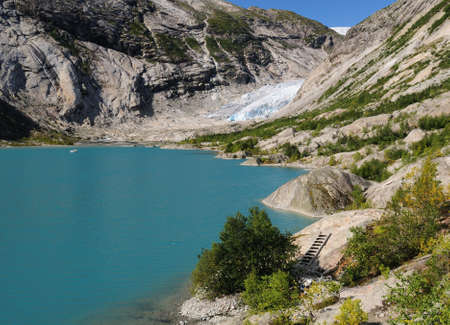 View From The Lake Nigardsbrevatnet To The Glacier Nigardsbreen In Jostedalsbreen National Park On A Sunny Summer Day With A Clear Blue Skyの写真素材