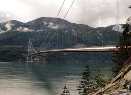 View To The Hardangerbrua Suspension Bridge At Eidfjord On An Overcast Summer Dayの写真素材