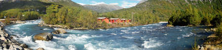 Panorama Of The Beautiful Wild River Jostedola With Water Passing Large Rocks And Boulders In Jostedalsbreen National Park On A Sunny Summer Dayの写真素材