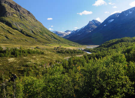 Mountains In The Barren Landscape Of The Icefields Of Jotunheimen National Park On A Sunny Summer Day With A Clear Blue Sky And A Few Cloudsの写真素材