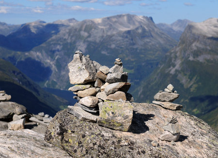 Rock Pile At Dalsnibba Lookout With The Large Mountains Of Geirangerfjord In The Background On A...