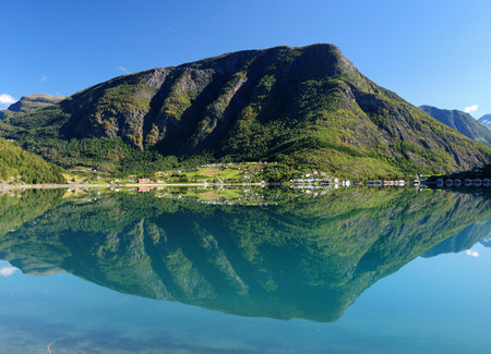 Mountains Reflecting In The Calm Water Of The Dalsfjord Near Skjolden On A Sunny Summer Day With A...