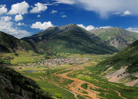 Aerial View From The Million Dollar Highway To Silverton Colorado Surrounded By Mountains On A Sunny Summer Day With A Clear Blue Sky And A Few Cloudsの写真素材