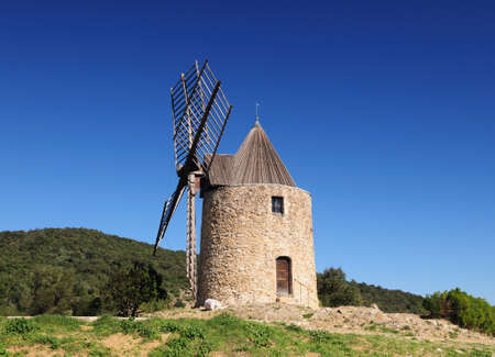 Ancient Windmill Moulin Saint Roch In The Hills Of Grimaud In Provence France On A Beautiful Autumn Day With A Clear Blue Skyの写真素材