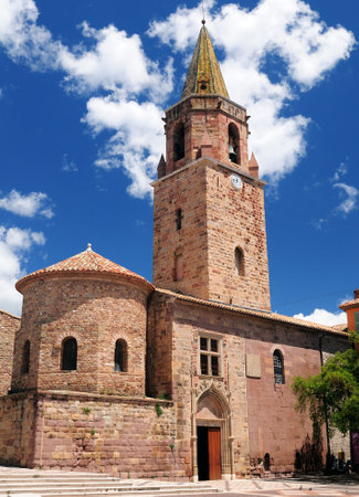Bottom Up View To The Clock Tower Of The Saint-Leonce Cathedral In Frejus France On A Beautiful Spring Day With A Few Clouds In The Clear Blue Skyの写真素材