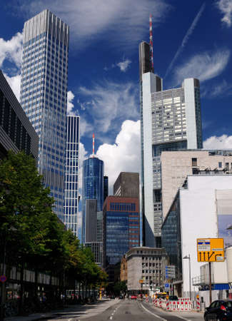 View From The Main River Into The Street Canyon Of The Banker's City Frankfurt Am Main In Hesse Germany On A Beautiful Summer Day With A Clear Blue Sky And A Few Cloudsの写真素材