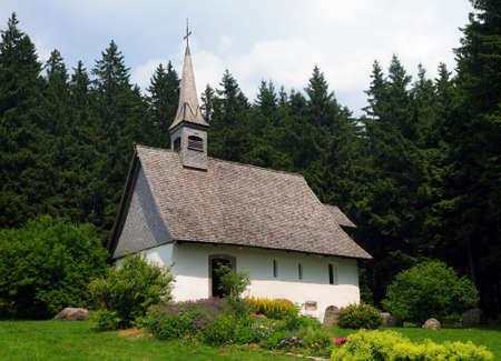 Little Ancient Chapel Martinskapelle In The Forest Near Triberg Black Forest Germany On A Beautiful Sunny Summer Day With A Clear Blue Sky And A Few Cloudsの写真素材