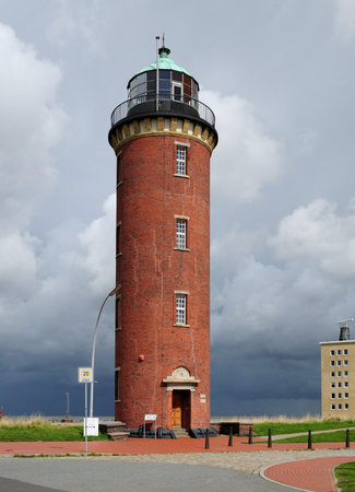 Thunderstorm Behind The Lighthouse Hamburger Leuchtturm In Cuxhaven Germany On A Beautiful Sunny Summer Day With A Blue Sky And A Few Cloudsの写真素材