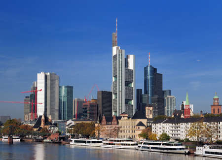 View From The Main River To The Skyline Of The Banker's City Frankfurt Am Main In Hesse Germany On A Beautiful Autumn Day With A Clear Blue Sky And A Few Cloudsのeditorial素材
