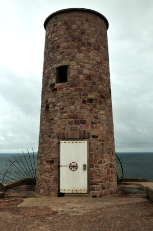 Close-Up Of The Historic Lighthouse At The Coast Of Cap Frehel Bretagne France On An Overcast Summer Dayの写真素材