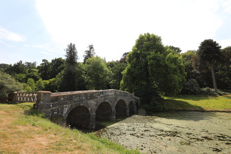 Old stone bridge over the river in the park. Summer landscape.の写真素材