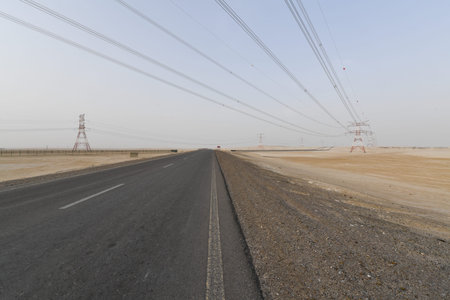 High voltage lines and pylons in the desert, closeup of photo