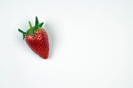 Fresh juicy strawberry with green leaves isolated at white backgroundの写真素材