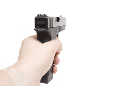 a hand is holding a handgun, isolated on white background