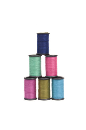 a pyramid of colorful spools of thread isolated on white