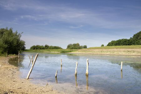Pond in the river foreland along the river Waal near the Dutch village Ochtenの写真素材