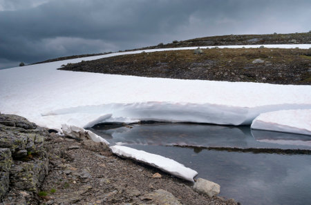 Snow covered landscape with a lake on the Norwegian mountain plateau Aurlandsfjellet close to Laerdalの写真素材