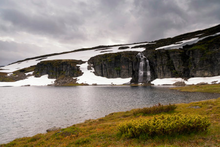 Waterfall flowing in a lake on the Norwegian mountain plateau Aurlandsfjelletの写真素材