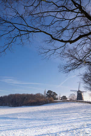 Windmill in a cold winter landscape near Ubachsbergの写真素材