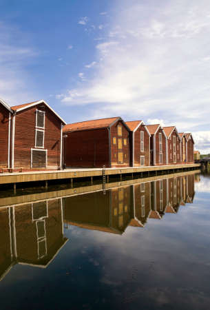 Wooden houses reflecting in the harbour in Hudiksvallの写真素材