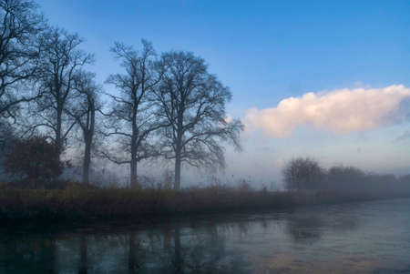 Misty and frozen canal near the village Heetenの写真素材