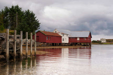 Wooden houses built on poles on a bay on the Atlantic coast close to the Norwegian village Vevangの写真素材