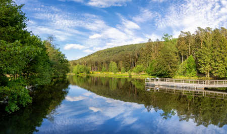 View at a lake in the Spiesswoogtal valley near the German village Fischbach bei Dahn in the Rhineland-Palatinateの写真素材
