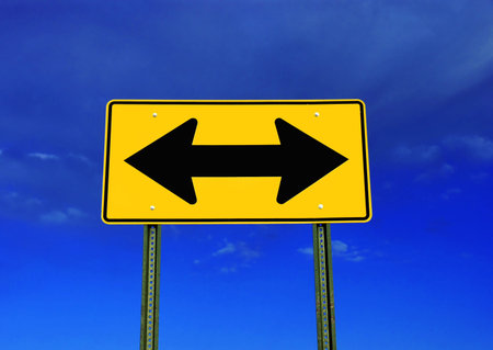 A road sign on a brilliant blue sky  Symbolizes a decision needs to be made 