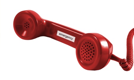 A red retro phone receiver isolated on red の写真素材